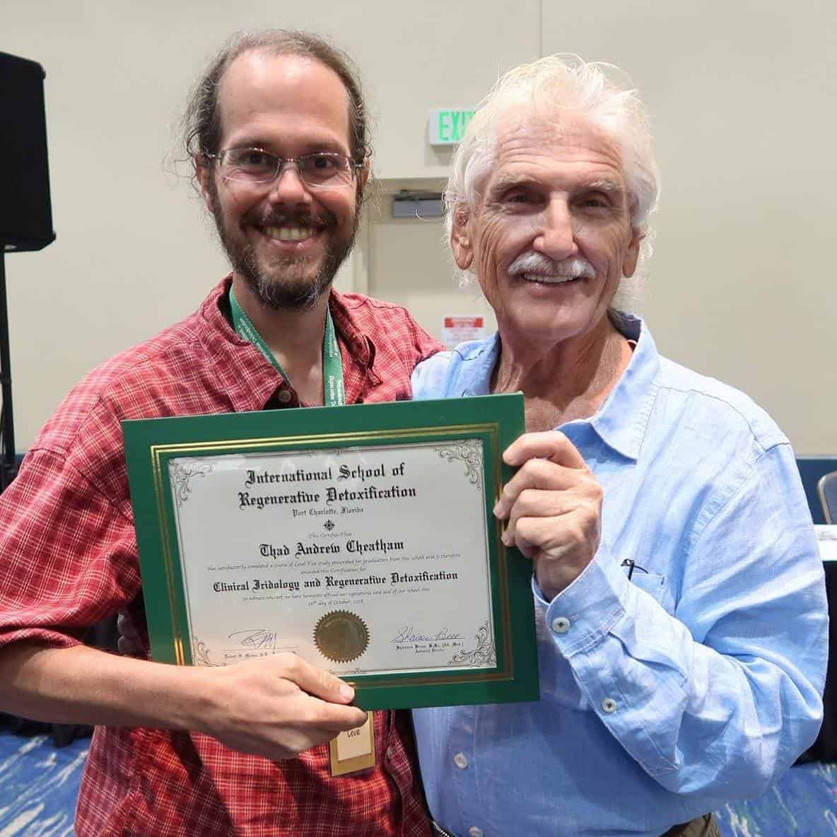 Thad displays Clinical Iridology and Regenerative Detoxification certificate with Dr. Morse at International School graduation.